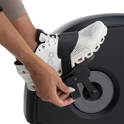 Person adjusting pedal strap on NordicTrack 10 Recumbent Bike