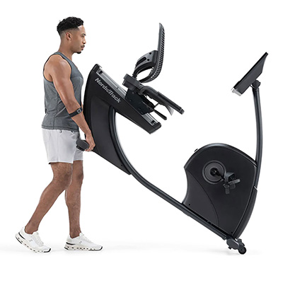 Person lifting NordicTrack 10 Recumbent Bike for storage