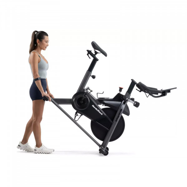 User moving the NordicTrack T Series 9 Bike using transport wheels