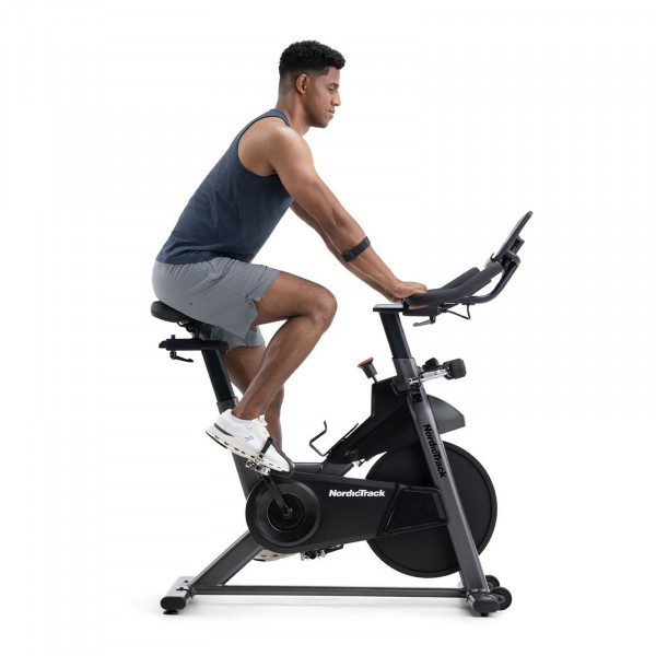 Side view of user riding the NordicTrack T Series 9 Bike