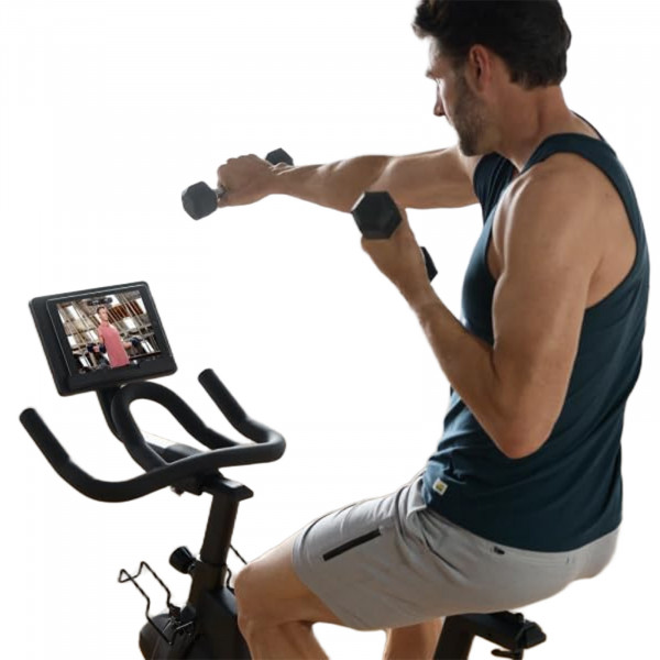 User doing upper body workout on the NordicTrack T Series 9 Bike