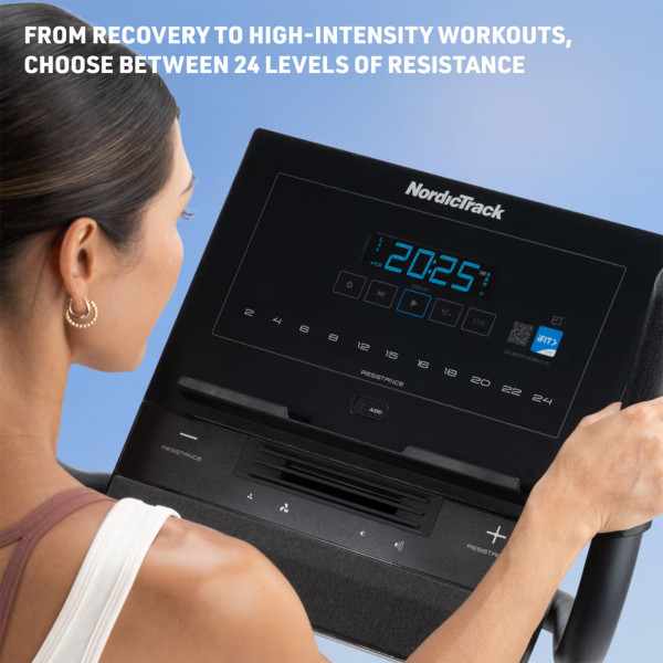 User adjusting resistance on the NordicTrack G LE Upright Bike console