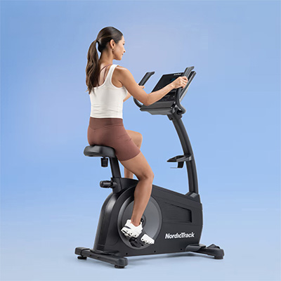User riding the NordicTrack G LE Upright Bike<br><br>
