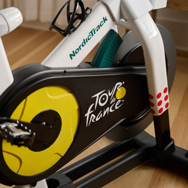 Close-up of the frame and flywheel on the NordicTrack Tour de France Indoor Bike with Tour de France branding.
