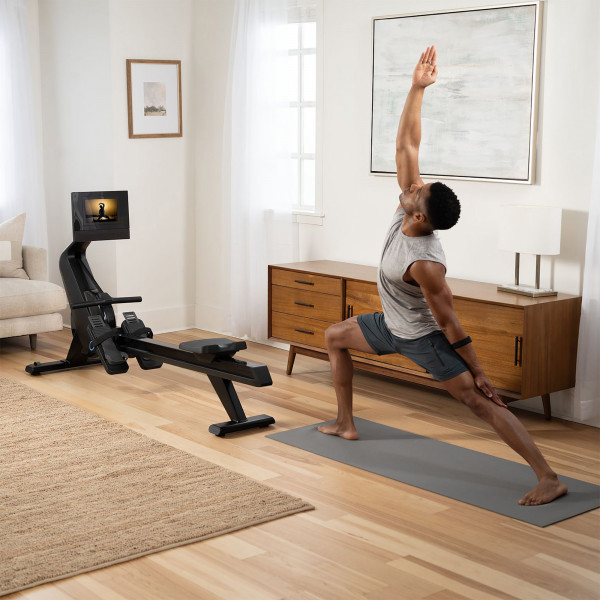 Model performing yoga beside the NordicTrack RW700 Rowing Machine