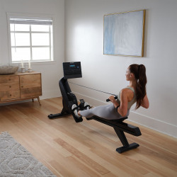 Model rowing on the NordicTrack RW300 Rower in a home setting