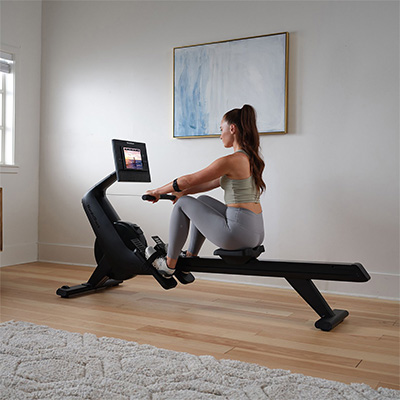 Model starting a rowing session on the NordicTrack RW300 Rower