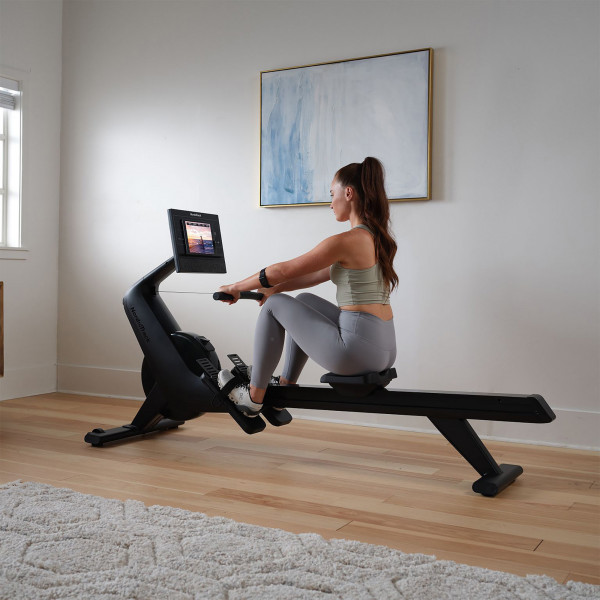 Model starting a rowing session on the NordicTrack RW300 Rower