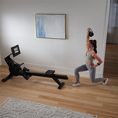Model doing a strength workout beside the NordicTrack RW300 Rower 