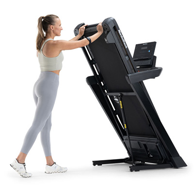 Model folding the NordicTrack T Series 7 Treadmill for storage