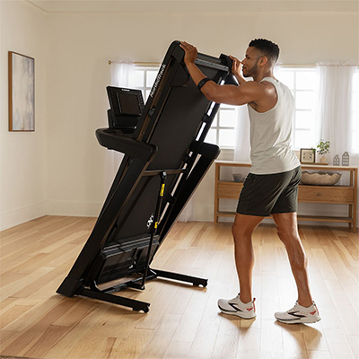 Model folding NordicTrack T Series 8 Treadmill for storage in home setting 