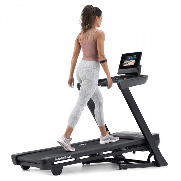 Person walking on the NordicTrack T Series 10 Treadmill at an incline.
