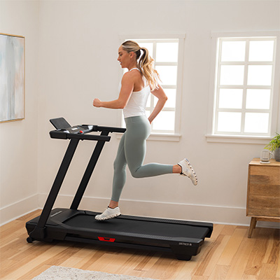 Model running on the NordicTrack T Series 5 Treadmill in a bright home setting 