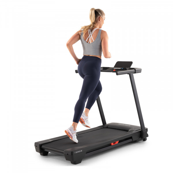 Model running on the NordicTrack T Series 5 Treadmill, rear view