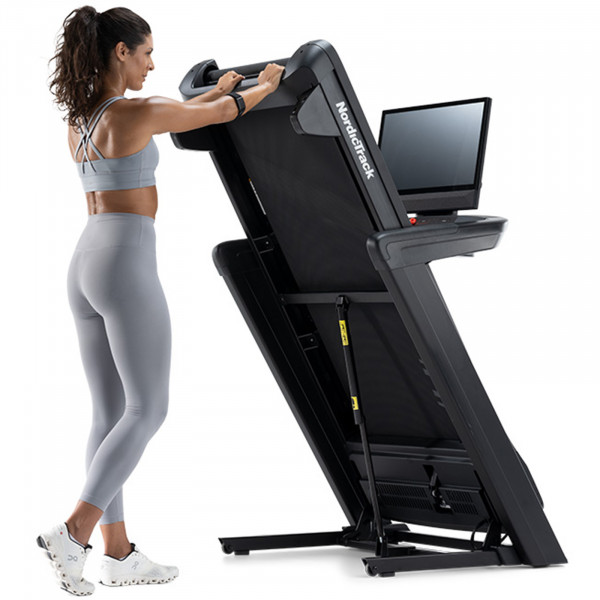 Person folding up the NordicTrack Commercial 2450 Treadmill.
