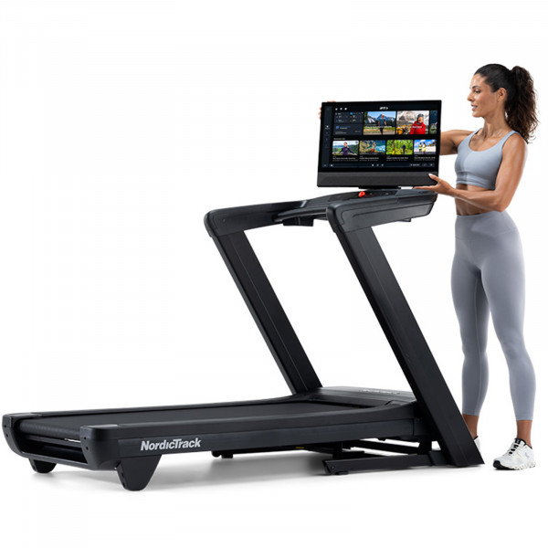 Person adjusting the 24" touchscreen on the NordicTrack Commercial 2450 Treadmill.
