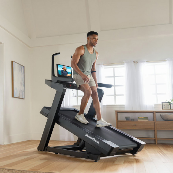 Model walking backwards on an inclined NordicTrack X16 Treadmill
