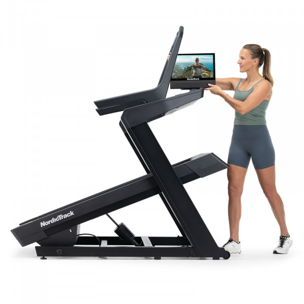 Model adjusting the touchscreen on the NordicTrack X16 Treadmill