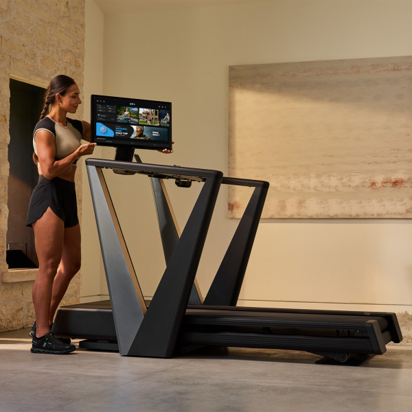 Model adjusting the pivoting screen on the NordicTrack Ultra 3 Treadmill