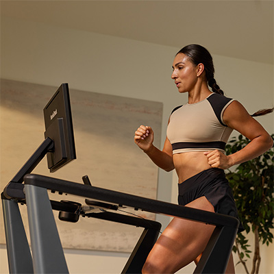 Front view of a model running on the NordicTrack Ultra 3 Treadmill  