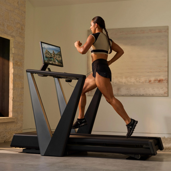 Rear view of a model running on the NordicTrack Ultra 3 Treadmill