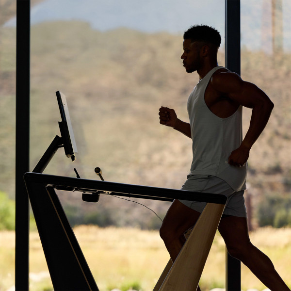 A backlit silhouette of a model running on the NordicTrack Ultra 1 Treadmill