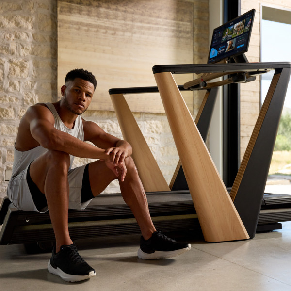 Model seated on the NordicTrack Ultra 1 Treadmill deck after a workout