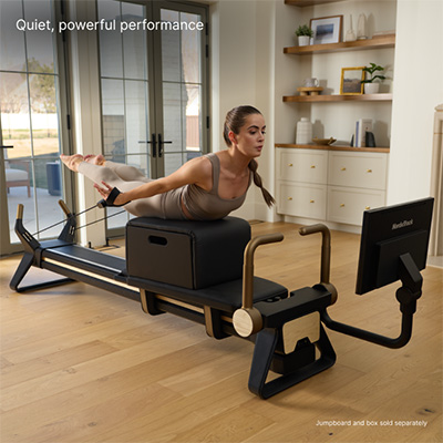 Model doing prone back extension on the NordicTrack Ultra 1 Reformer 