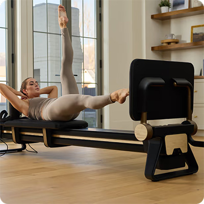 Model doing side leg lift on the NordicTrack Ultra 1 Reformer<br />JUMPBOARD  