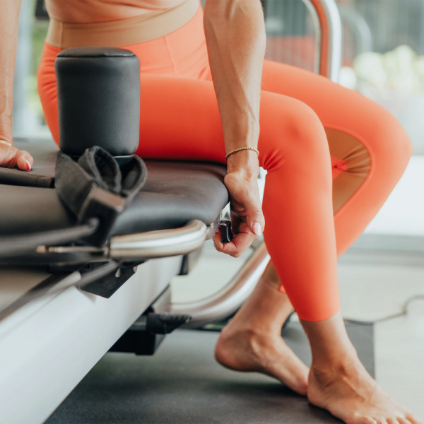 Close-up of hand releasing the carriage lock on the NordicTrack Ultra 1 Reform RX-S