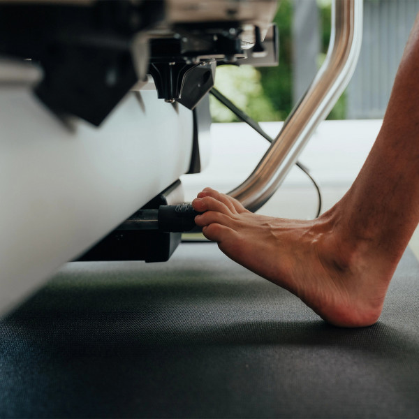 Close-up of foot pressing the resistance bar on the NordicTrack Ultra 1 Reform RX-S