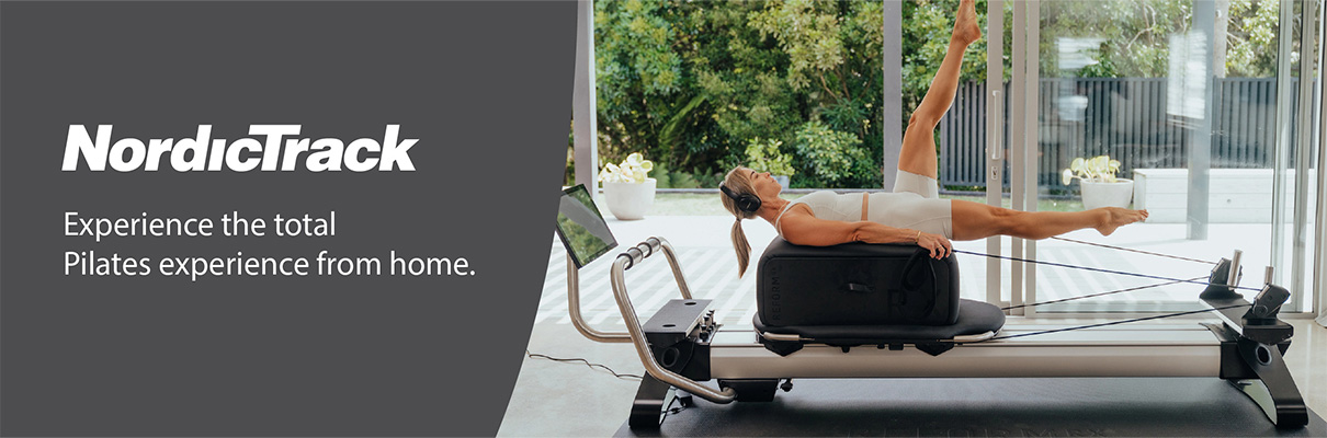 Model performing a supine leg extension exercise on the NordicTrack Ultra 1 Reform RX-S in a product banner