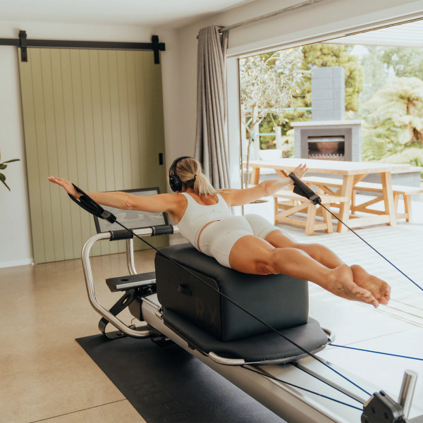 Prone back extension exercise using straps on the NordicTrack Ultra 1 Reform RX-S