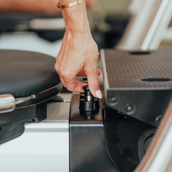 Close-up of hand adjusting resistance knob on the NordicTrack Ultra 1 Reform RX-S