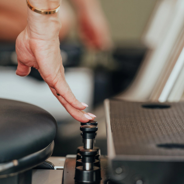 Close-up of finger adjusting resistance selector pins on the NordicTrack Ultra 1 Reform RX-S