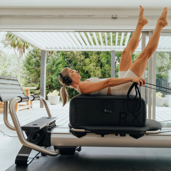 Supine leg lift exercise with straps on the NordicTrack Ultra 1 Reform RX-S