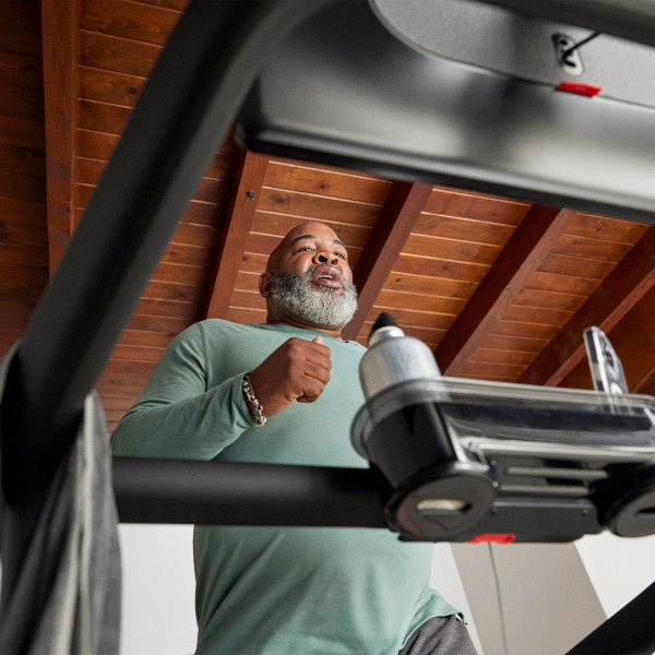 Low-angle view of a person running on the Peloton Original Series Tread