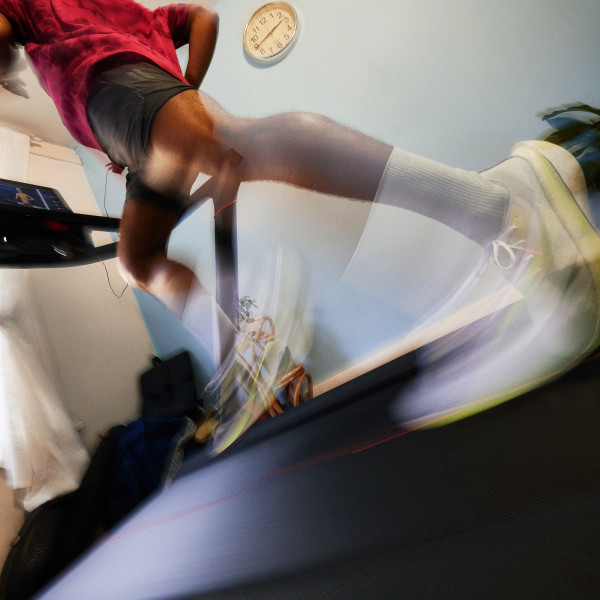 Blurred motion shot of a person sprinting on the Peloton Original Series Tread
