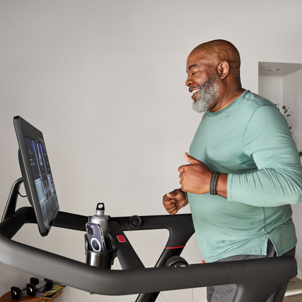 Person smiling while running on the Peloton Original Series Tread