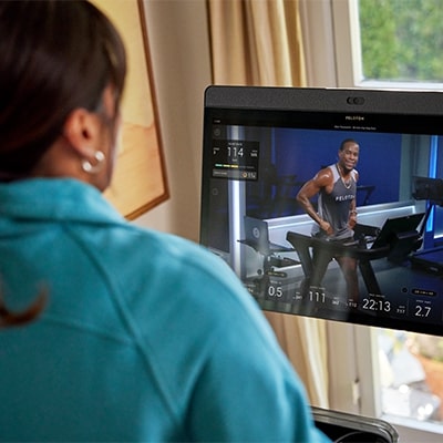 Close up of the Peloton Original Series Tread touchscreen showing a running class