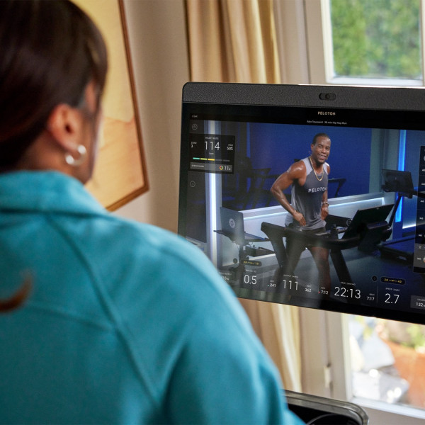 Close up of the Peloton Original Series Tread touchscreen showing a running class