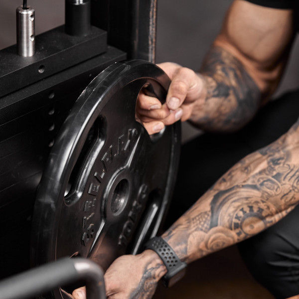 Lifestyle image of the Power Pin being used on a weight stack and loaded with weight plates
