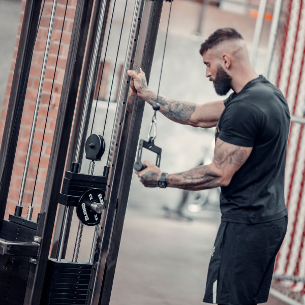 Lifestyle image of the Power Pin being used on a weight stack
