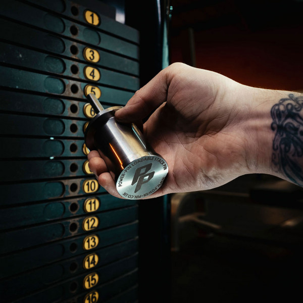 Lifestyle image of the Power Pin being plugged into a weight stack