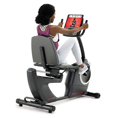 Rear angled view of a user cycling on the ProForm 325 CSX Recumbent Bike 