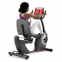 Rear angled view of a user cycling on the ProForm 325 CSX Recumbent Bike