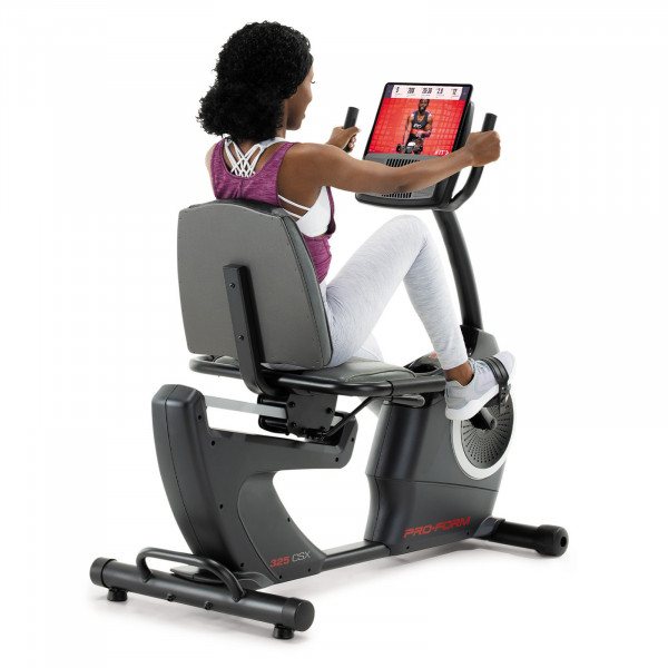 Rear angled view of a user cycling on the ProForm 325 CSX Recumbent Bike