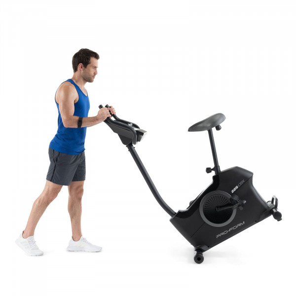 Model moving the ProForm 225 CSX Upright Exercise Bike using transport wheels