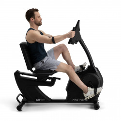 Side profile view of a user cycling on the ProForm 325 CSX Recumbent Bike