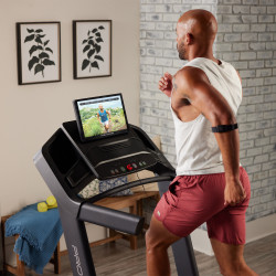 Close angled shot of a model running on the ProForm Carbon Pro 9000 Treadmill during an iFIT workout
